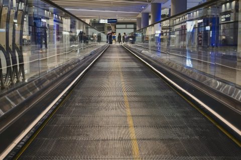 Travelers walking through a modern airport terminal, reflecting 2026 travel trends