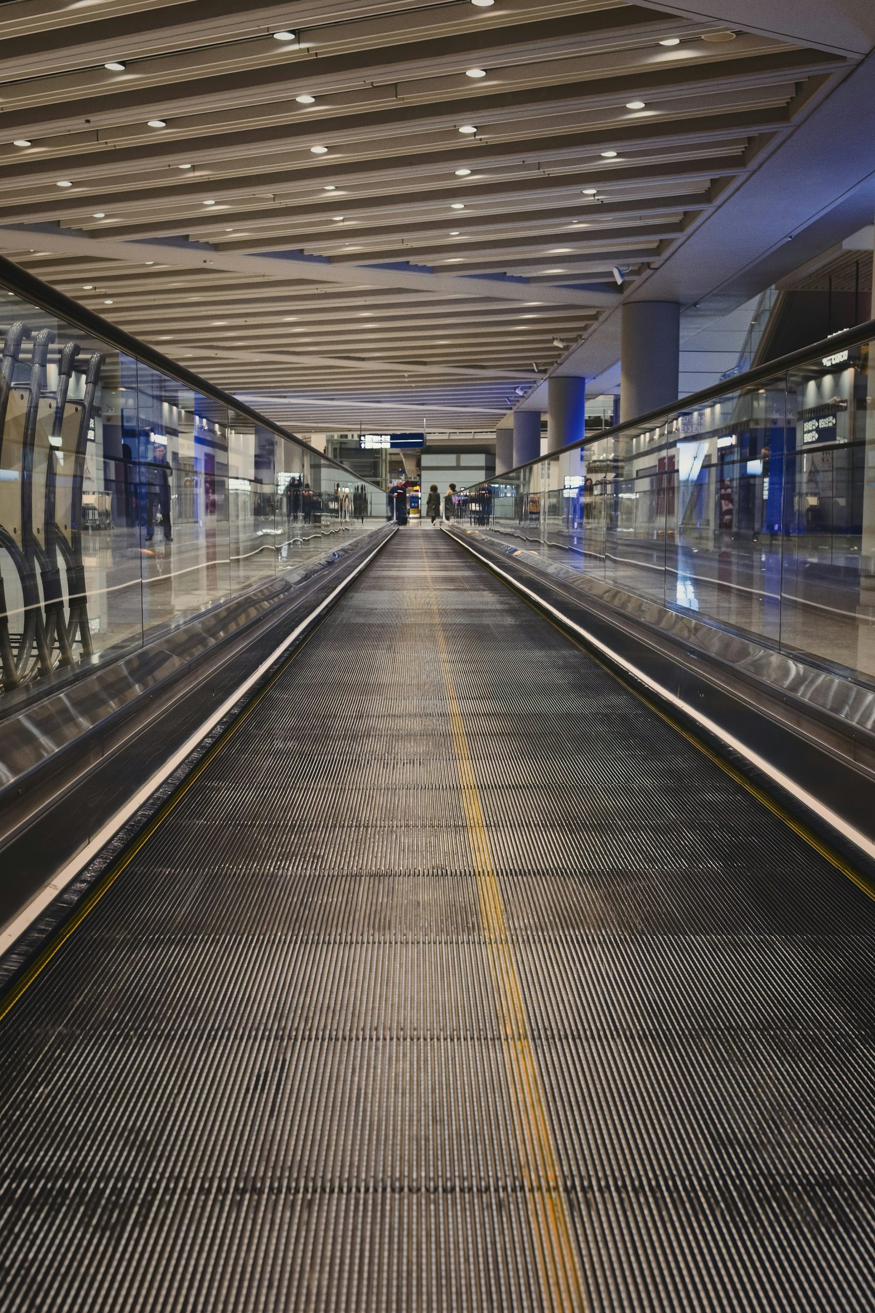 Travelers walking through a modern airport terminal, reflecting 2026 travel trends