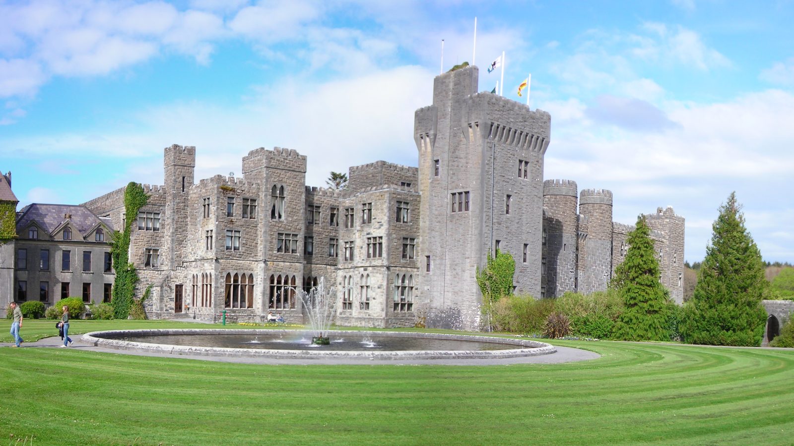 Ashford Castle, a five-star castle hotel in Ireland, seen across its lakeside grounds