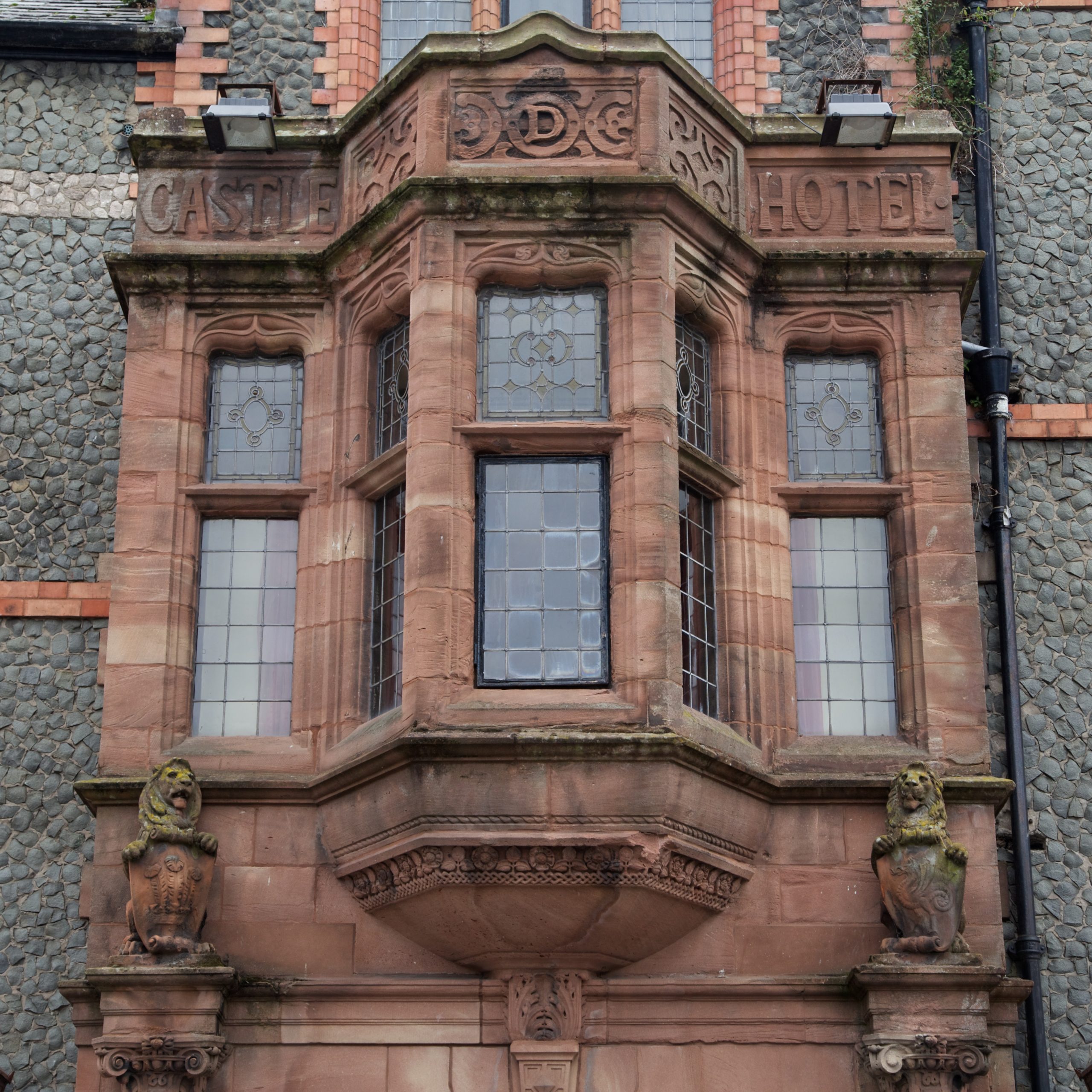 Decorative oriel window on the facade of the historic Castle Hotel in Conwy, Wales