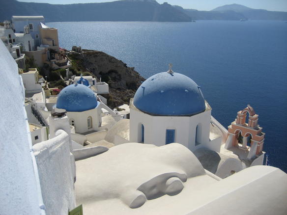A traditional Cycladic church in Oia, Santorini surrounded by whitewashed walls