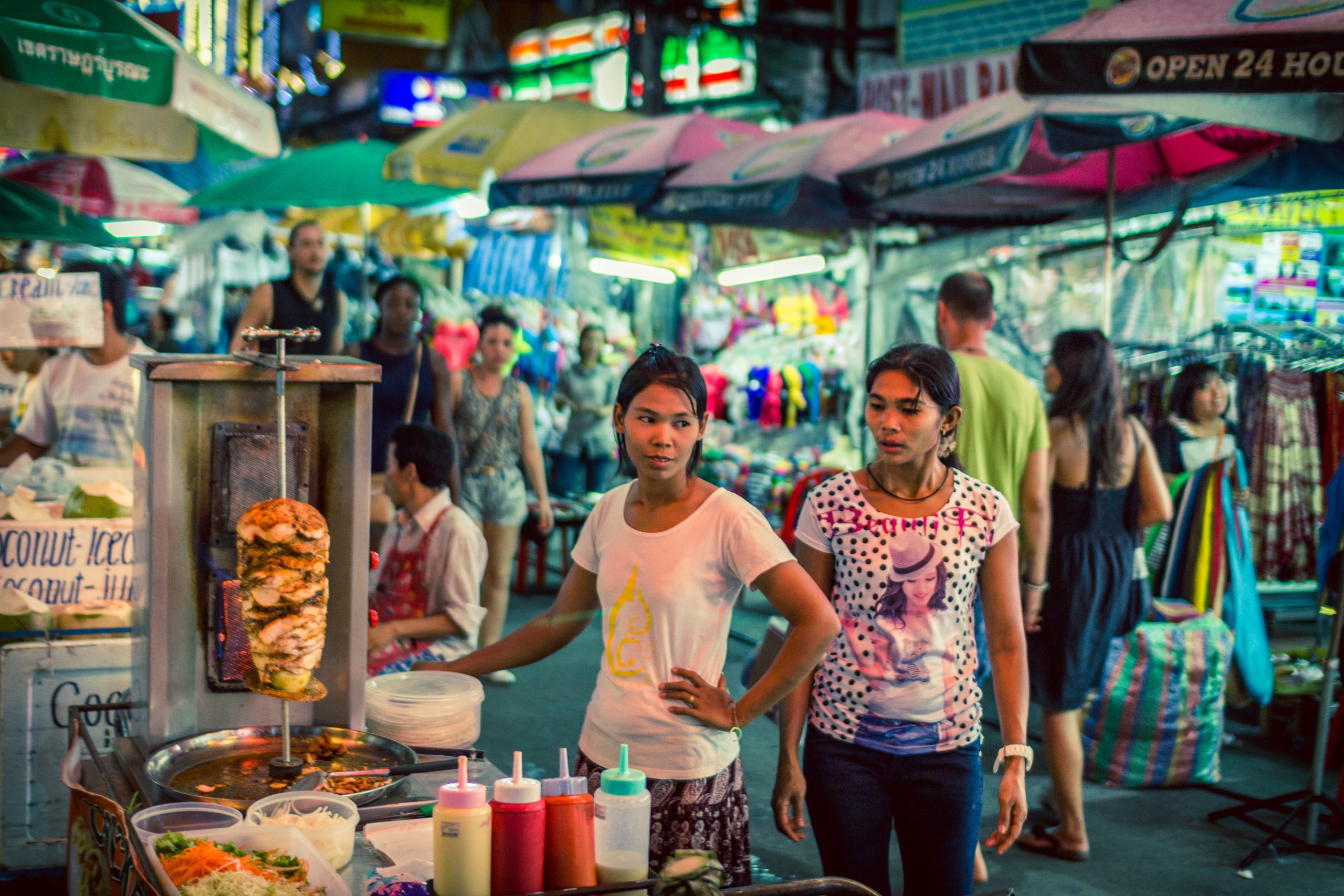 Street food vendor grilling skewers at a stall, a top pick for where to eat in Bangkok