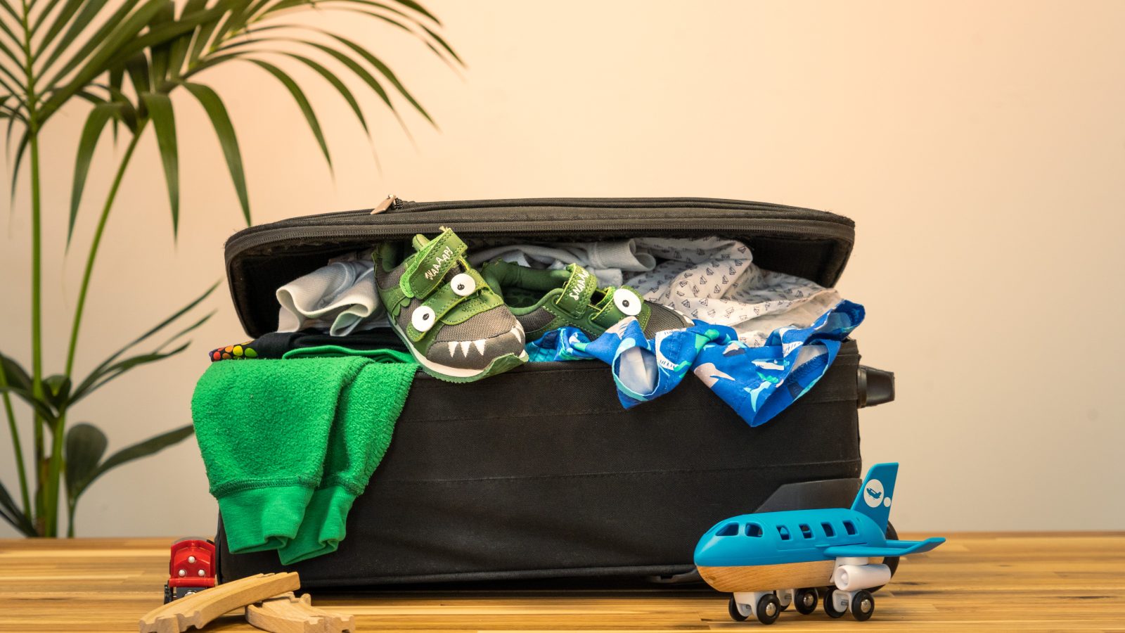 Beach vacation packing list photo of an overflowing suitcase before a trip