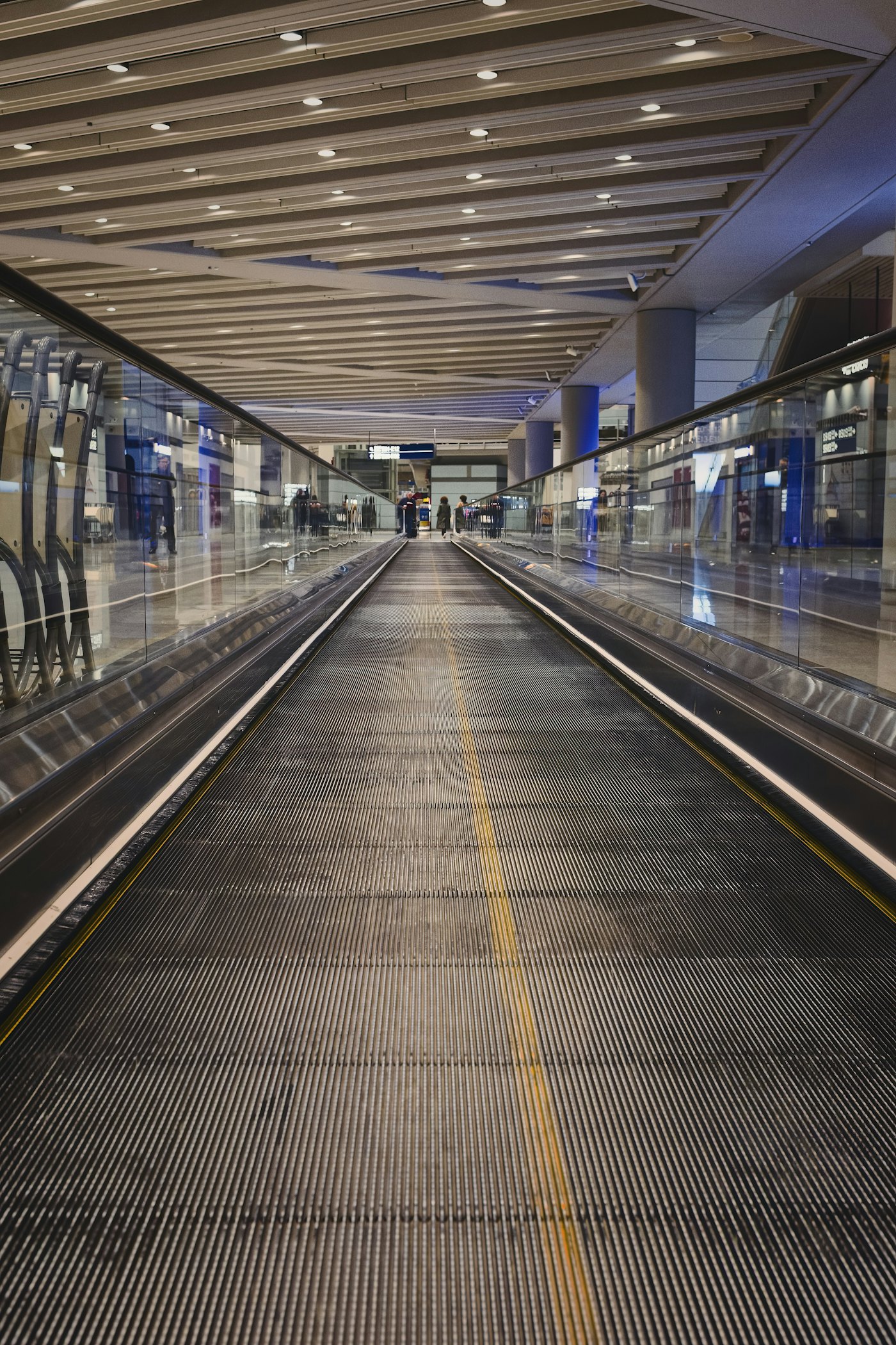 Traveler walking through an airport terminal with only a carry-on bag
