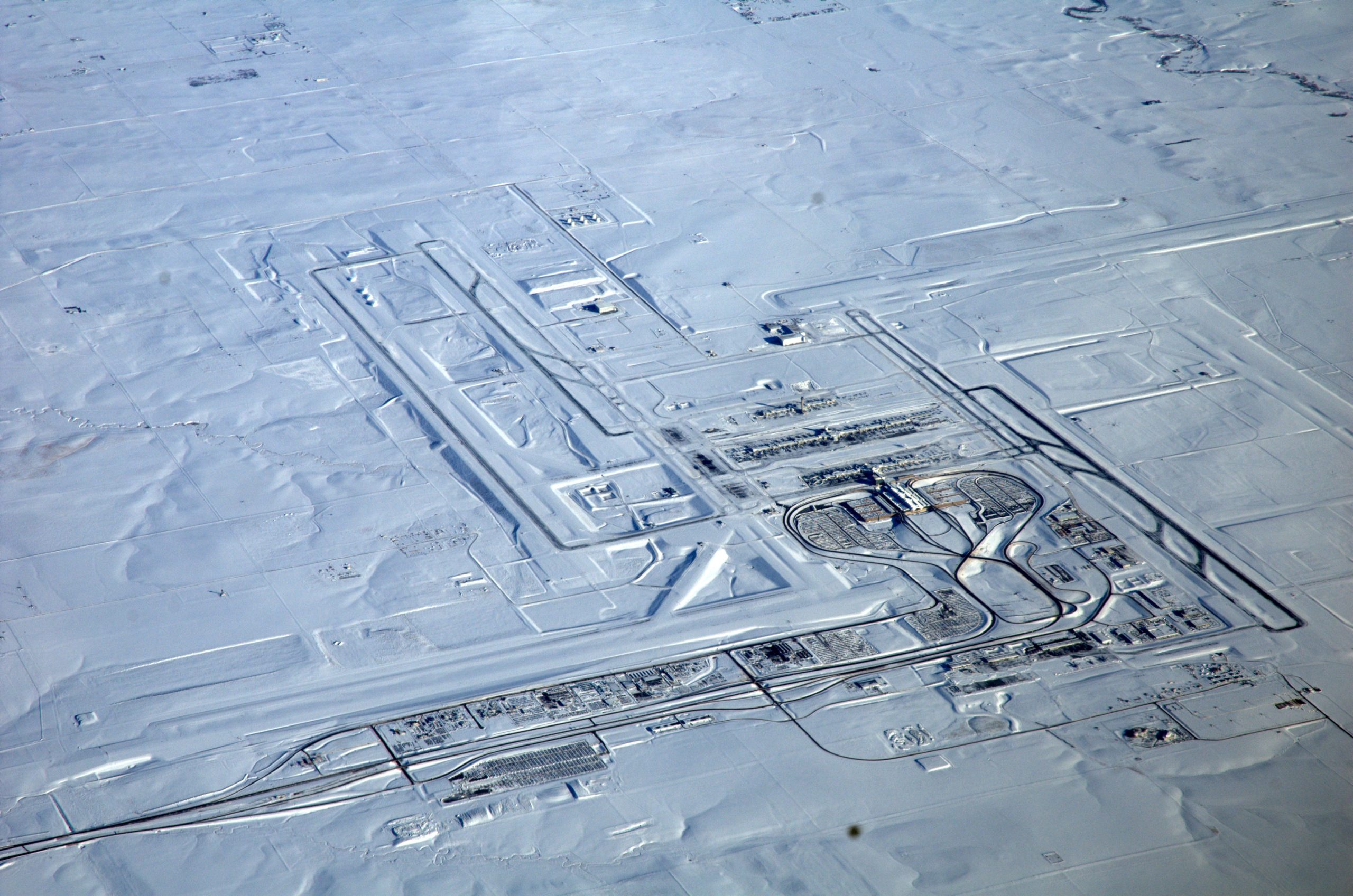 Snowy airport scene showing the reality of winter departures for cold-weather travel