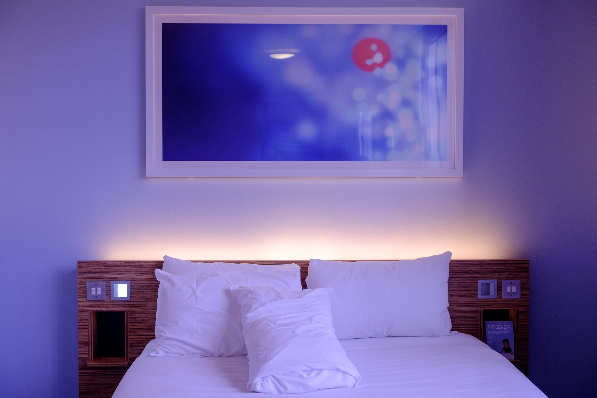Cozy quiet hotel bedroom reflecting the hushpitality hotel trend
