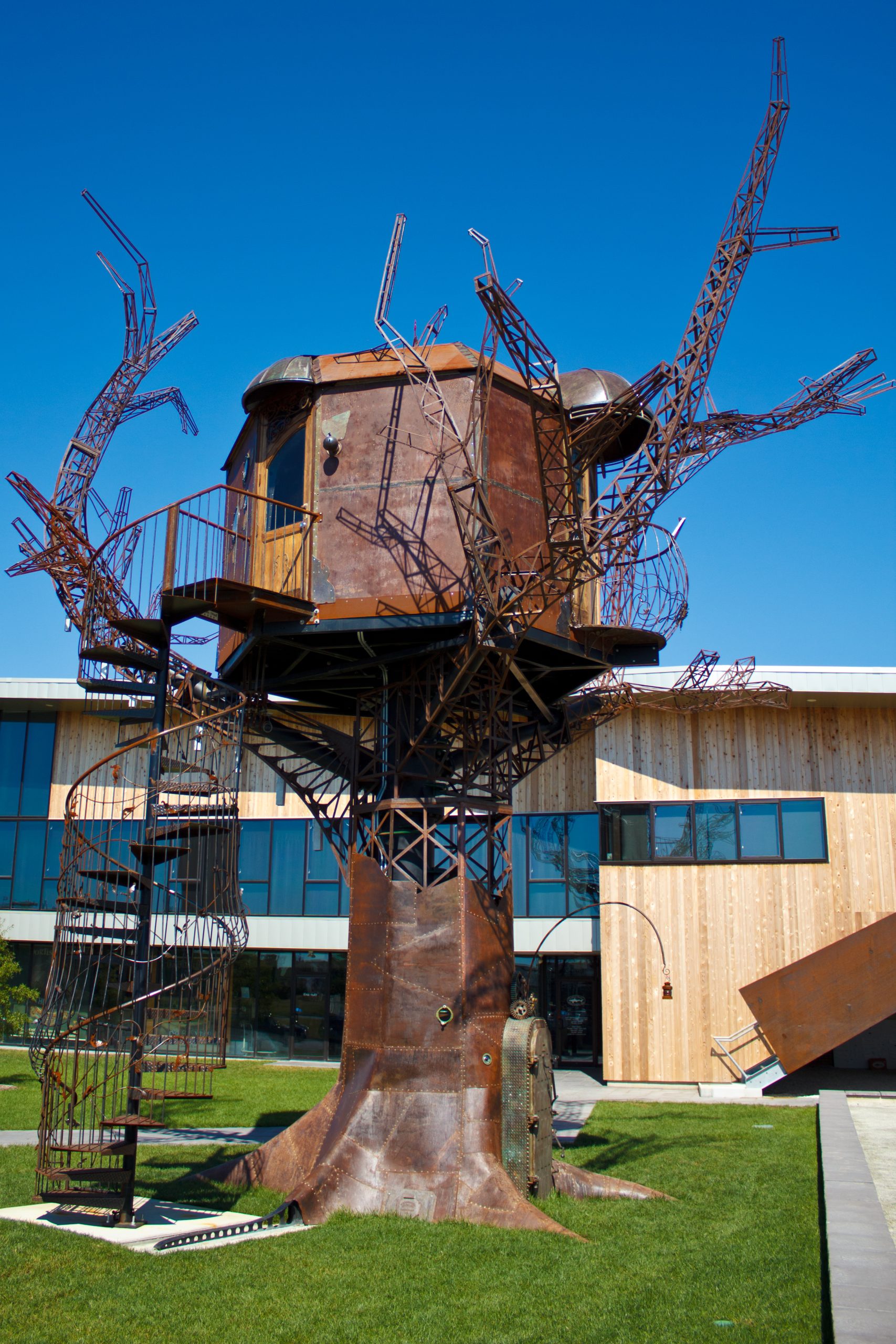 A raised treehouse-style hotel building surrounded by trees