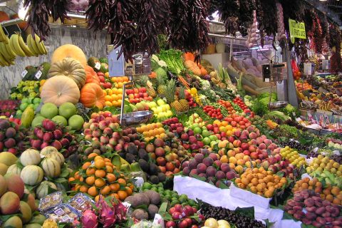 Fresh produce stalls at La Boqueria market, one of the best food cities in Europe for a culinary trip