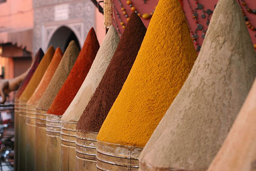 Pyramids of colorful spices for sale in a Marrakech souk