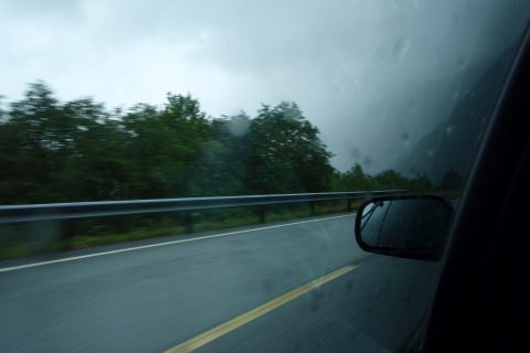 Road trip packing list open car trunk with luggage