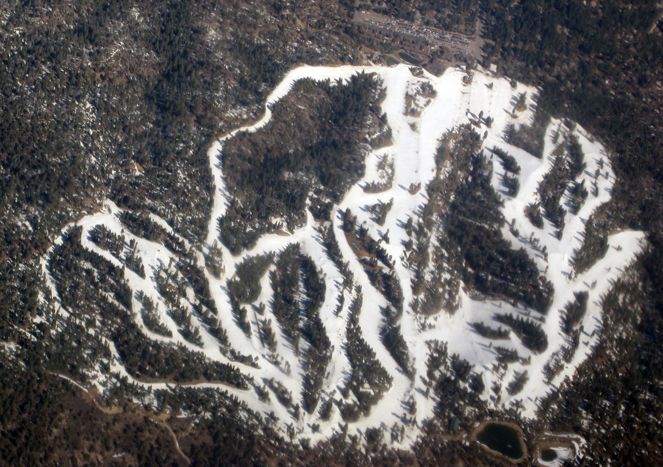 Snowy ski slopes and lift lines at a mountain resort