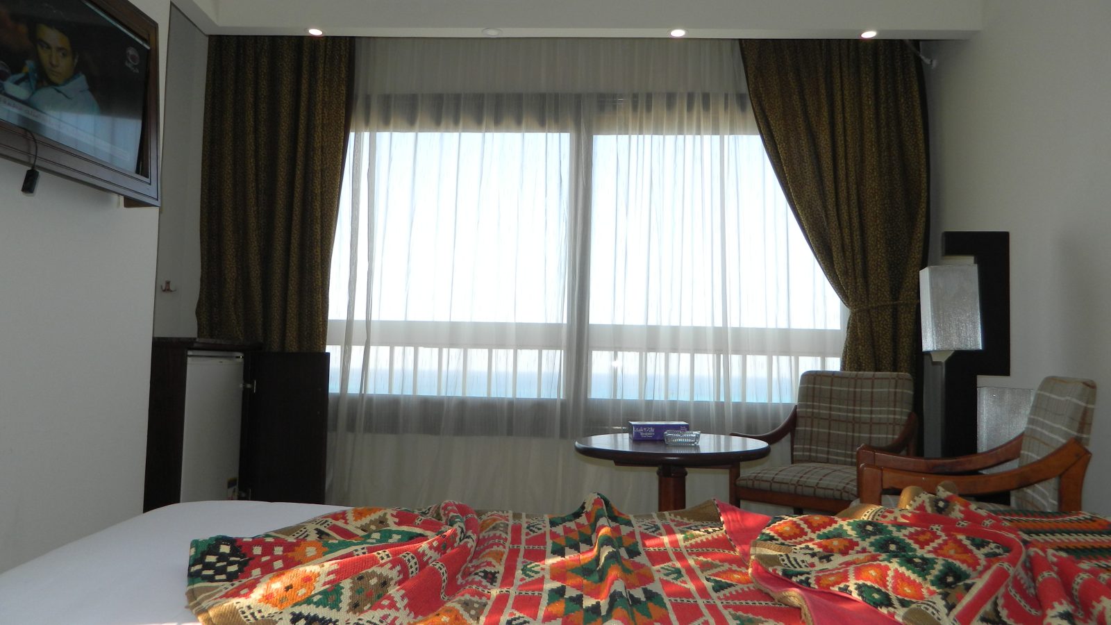 A calm hotel bedroom designed for sleep tourism, with sea-side windows