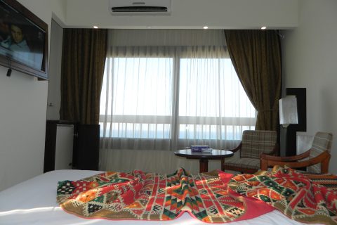 A calm hotel bedroom designed for sleep tourism, with sea-side windows