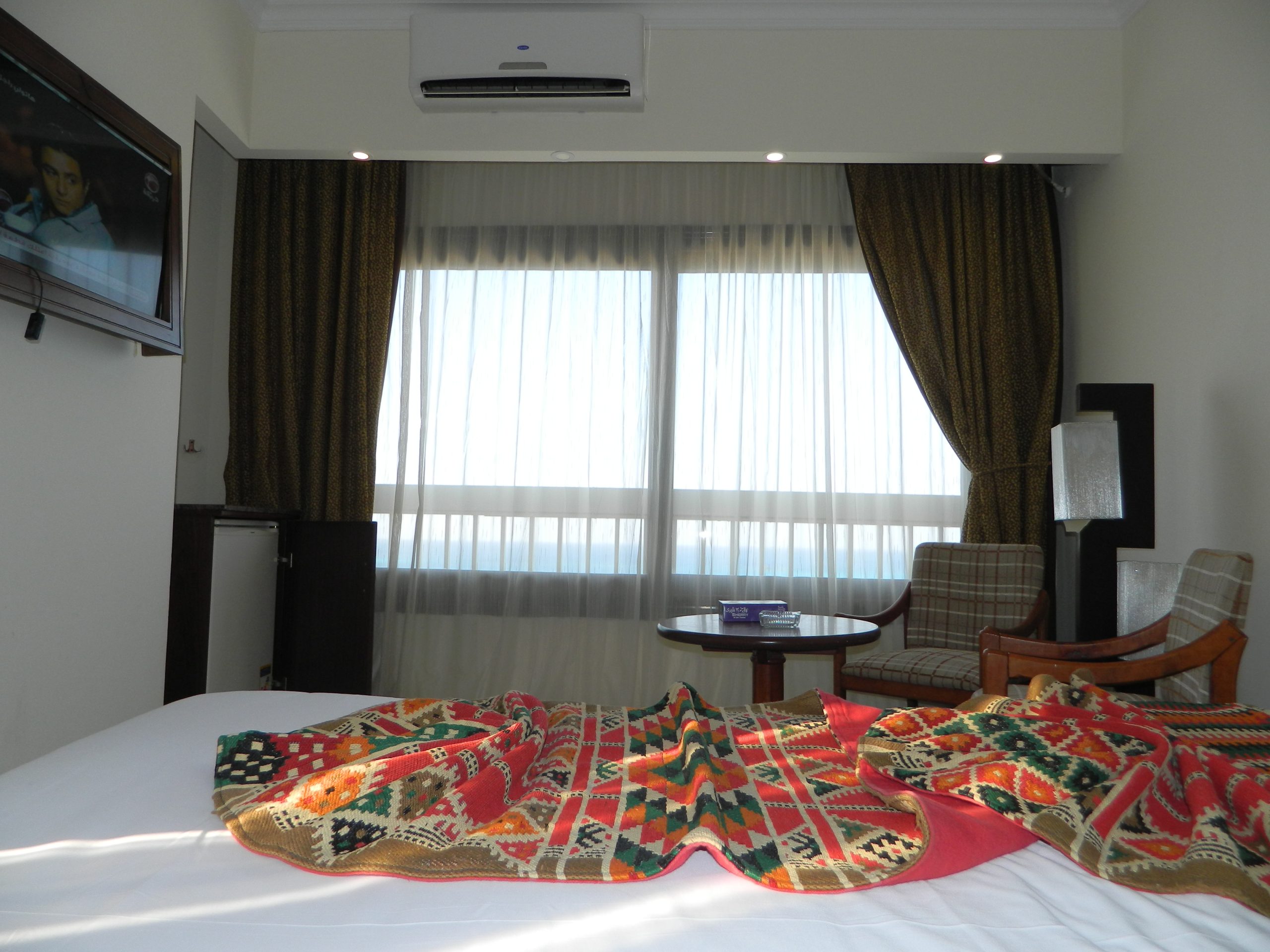 A calm hotel bedroom designed for sleep tourism, with sea-side windows