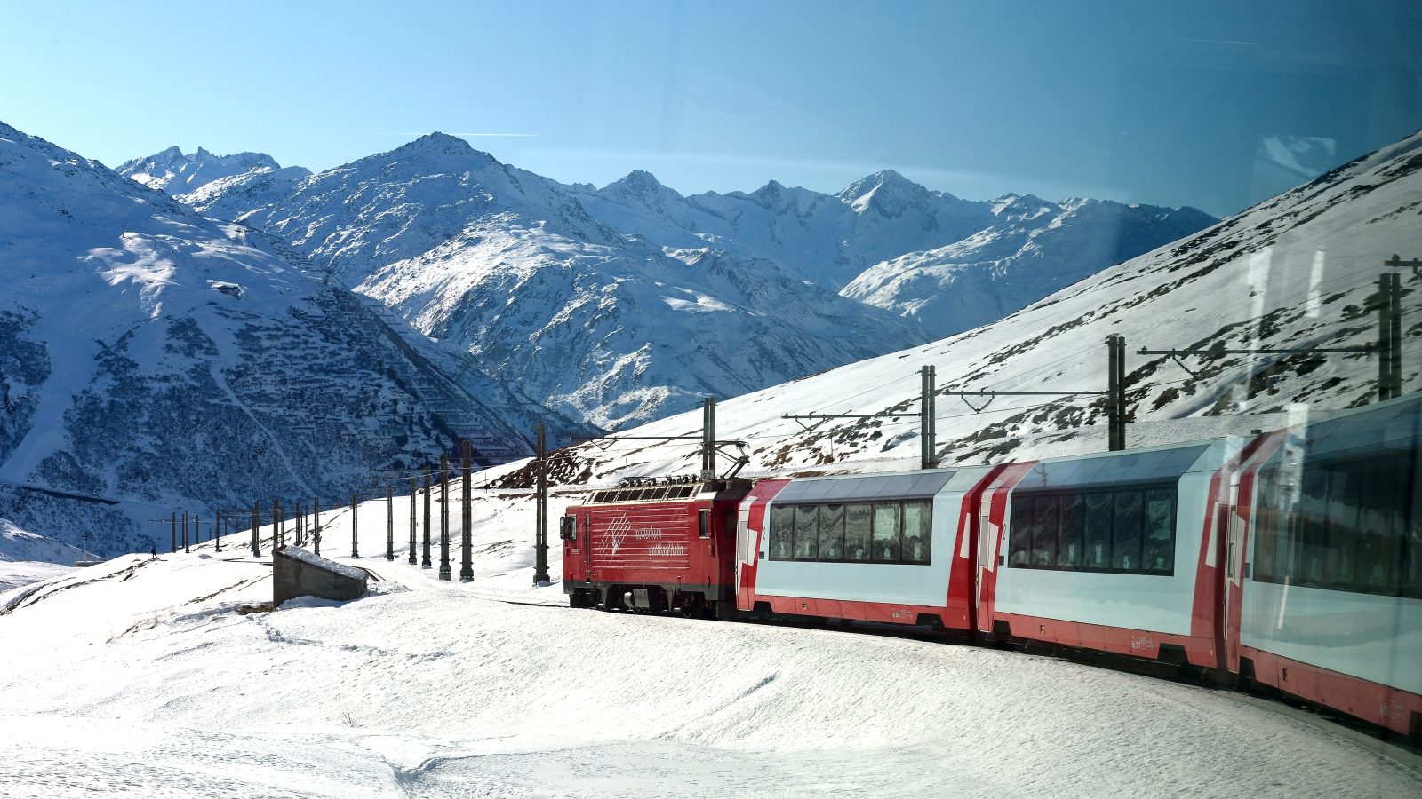 Glacier Express train winding through the Swiss Alps, an icon of slow train travel in Europe
