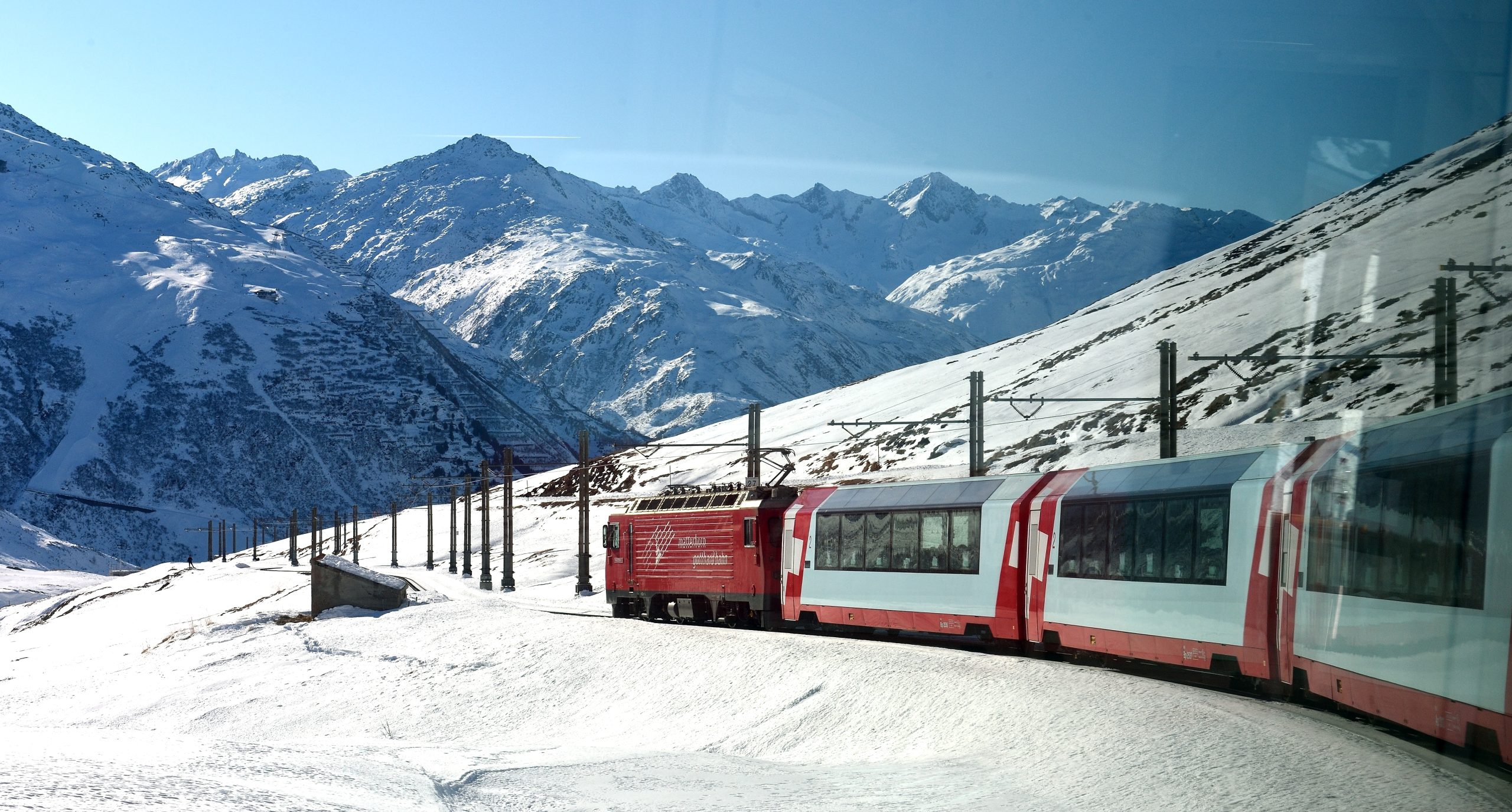 Glacier Express train winding through the Swiss Alps, an icon of slow train travel in Europe