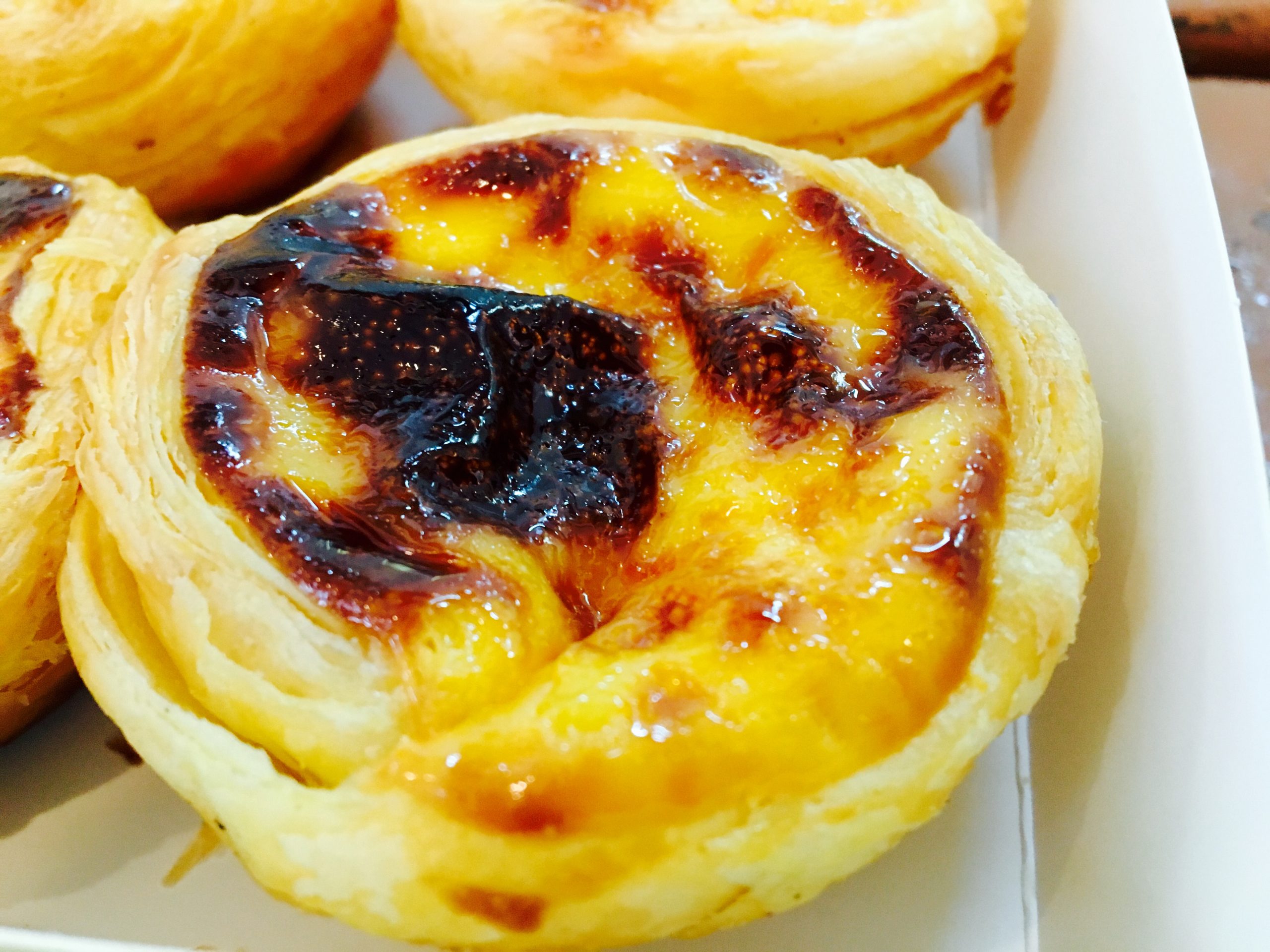 Where to eat in Lisbon close-up of a warm pastel de nata custard tart