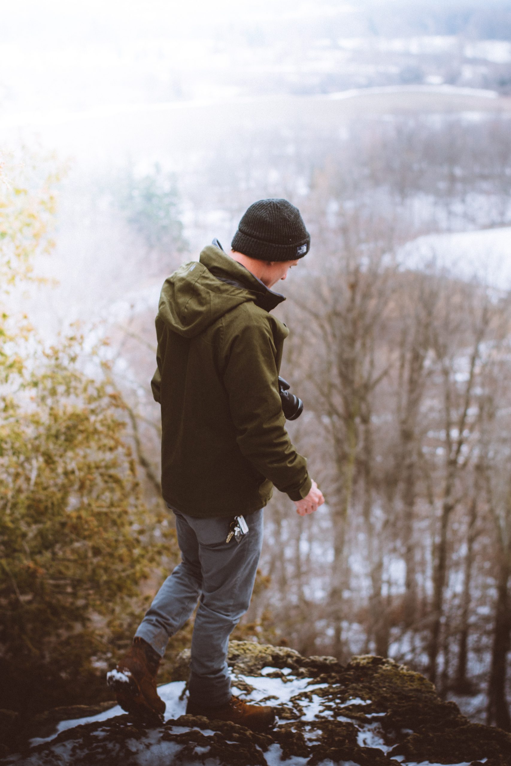 Hikers wearing layered winter clothing on a snowy trail